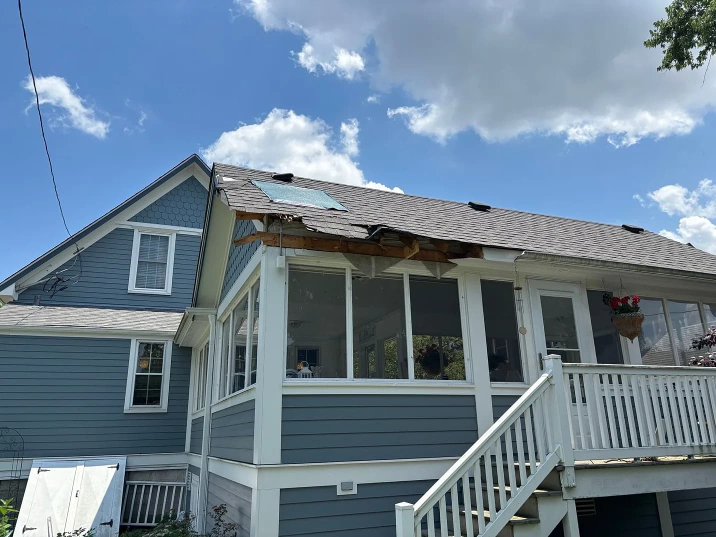 Storm-damaged roof and exterior before restoration by Heritage Contractors