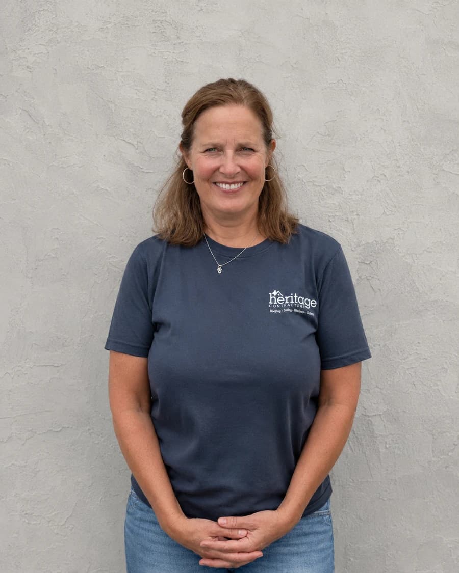 Mary P., Owner and President of Heritage Contractors, in a navy crewneck shirt