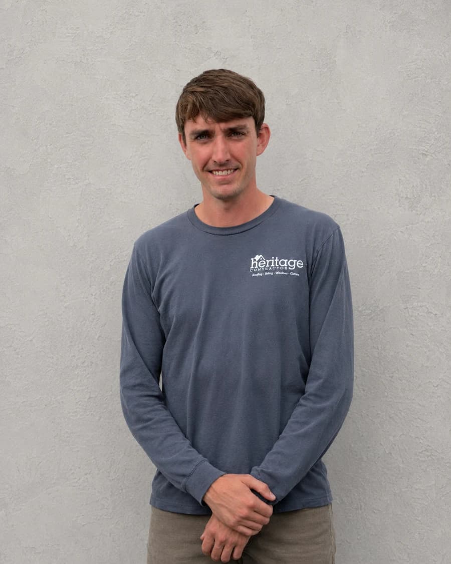 Danny F., Production Manager at Heritage Contractors, in a navy long-sleeve shirt